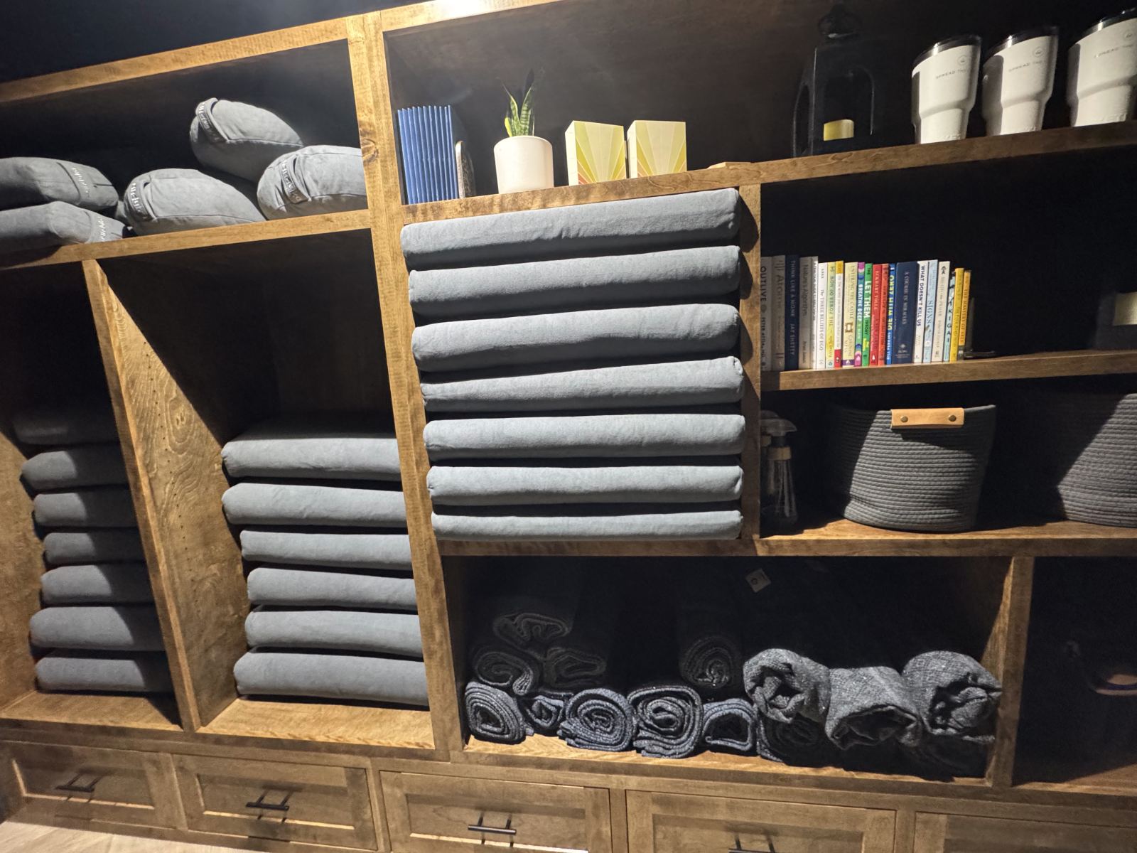 Shelves of bolsters and blankets for class