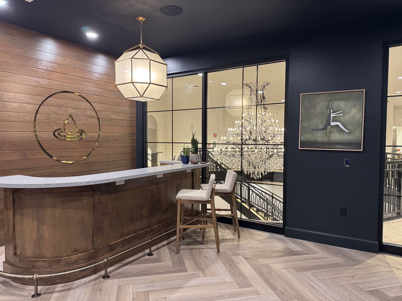 The reception desk with the Spread the Health logo and the chandelier in the window
