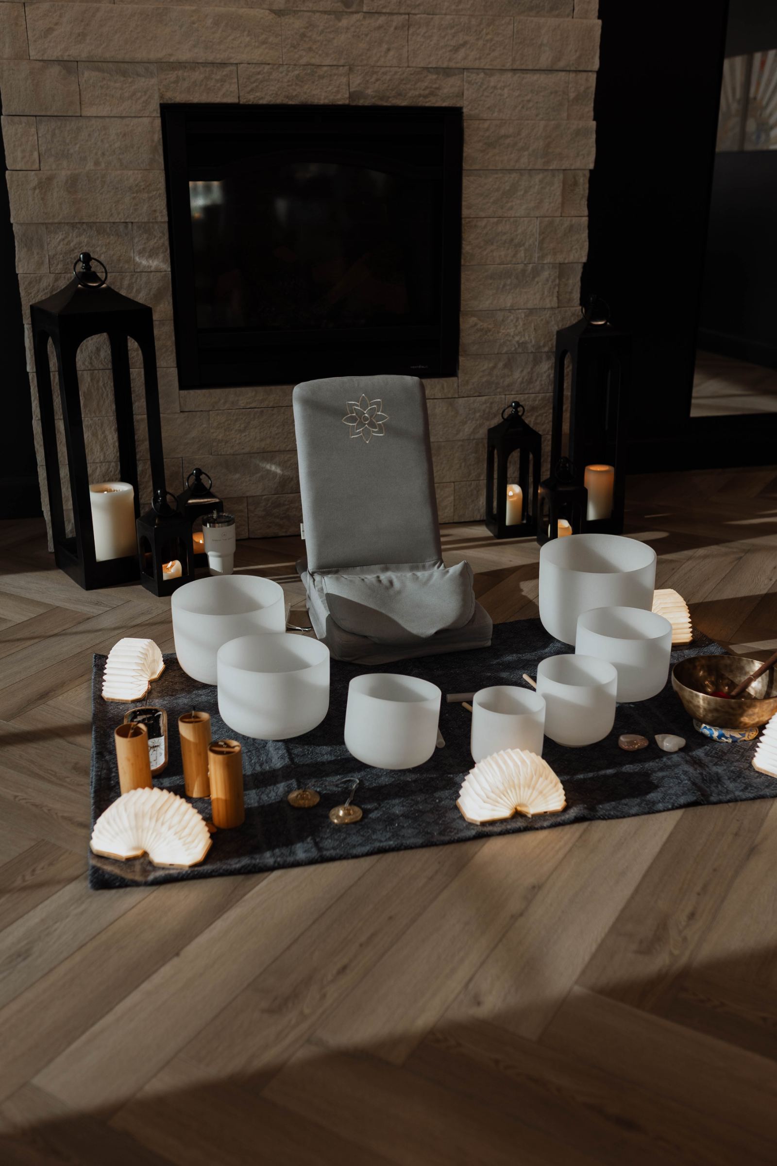 Sound bowls set by the fireplace for a private session
